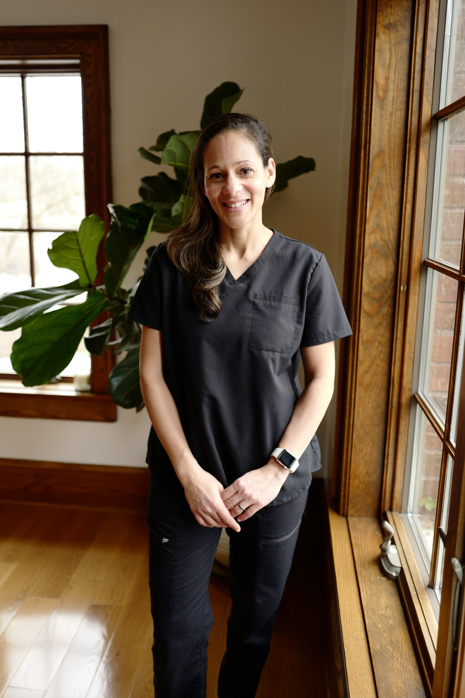 Alexandra, an osteopath in Grand Rapids, standing in her wellness and Pilates practice