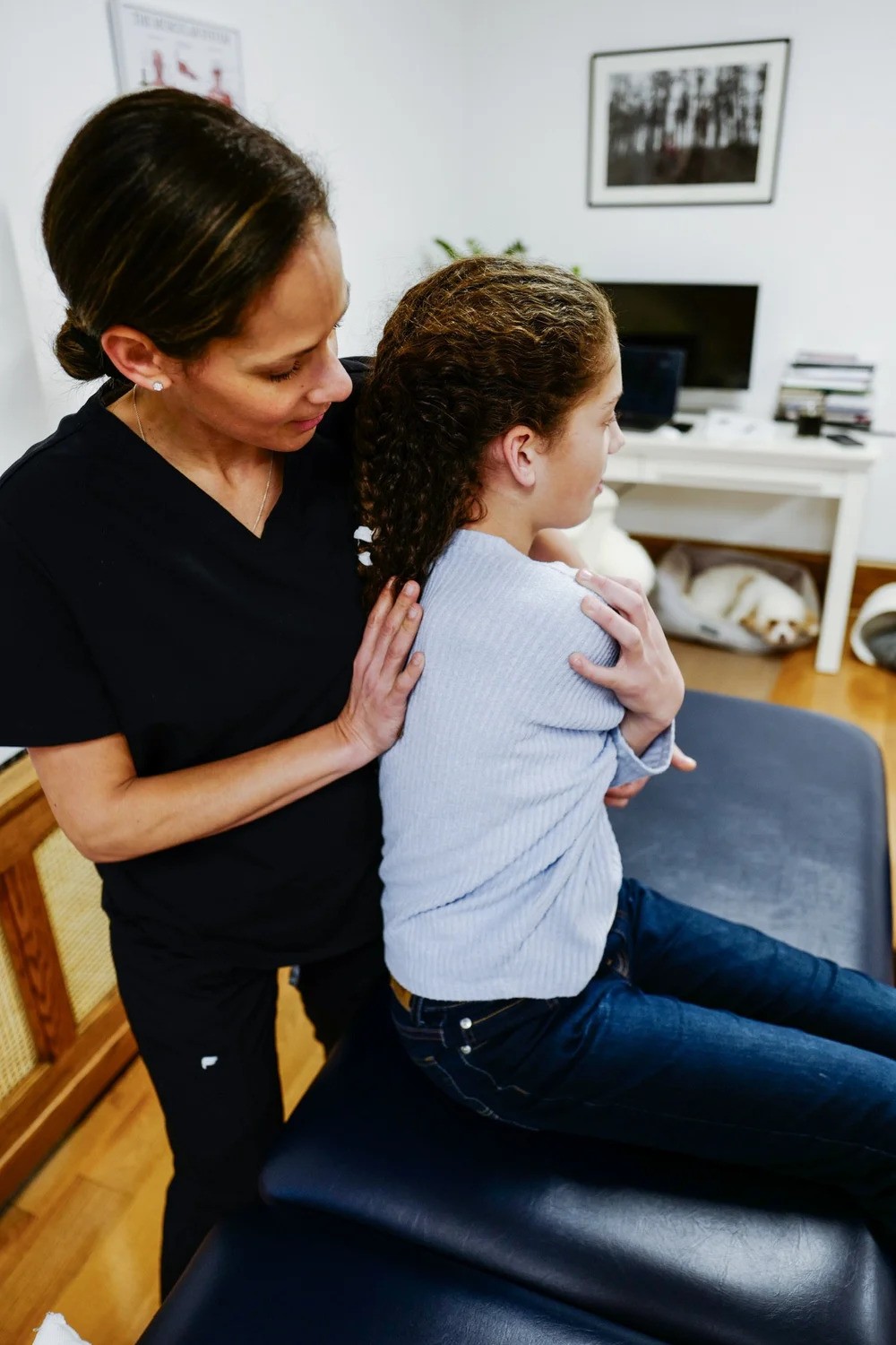 osteopath-hands-on-treatment Alexandra, an osteopath in Grand Rapids, using hands-on osteopathic treatment on one of her patients